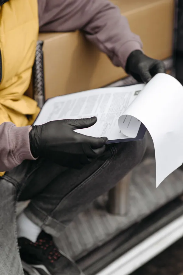 Worker reviewing paperwork, representing lead credit records
